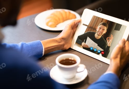 Preview: Two Men Having Online Video Call On Tablet