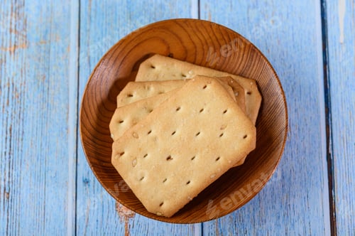 Preview: Stack many types of cookies on a plate and put on a wooden table.