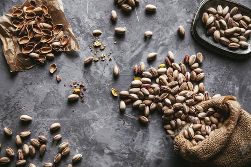 Preview: Roasted pistachios on natural wooden table background