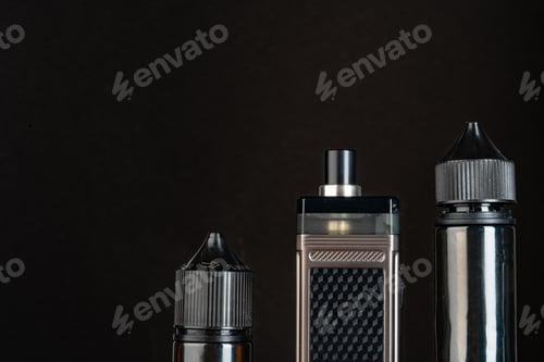Preview: Vape and vape liquid bottles against black background