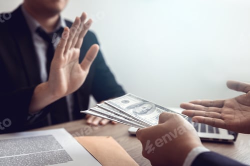 Preview: Businessperson refusing bribe given money by partner with anti bribery corruption concept.