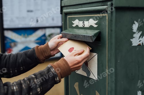 Preview: Posting letter to old postbox on street