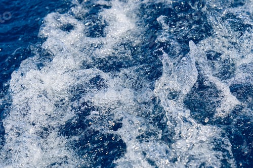 Preview: Abstract blue sea water with white waves. Blue sea texture with waves and foam. Mediterranean sea
