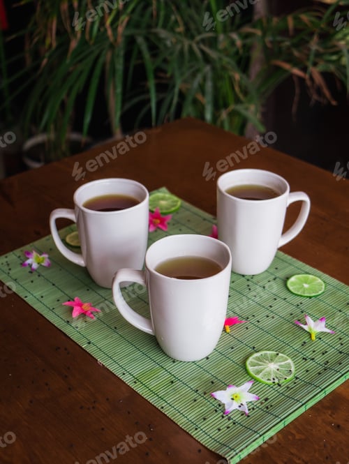 Preview: Selective focus shot of hot tea in a white mug placed on the table with a blurred background