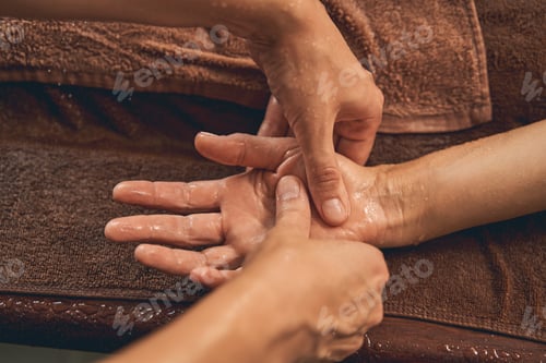 Preview: Woman receiving hand massage in wellness center