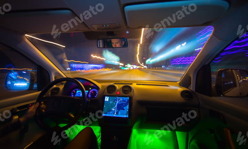 Preview: The man drive a vehicle on the night road. Inside view. Wide angle