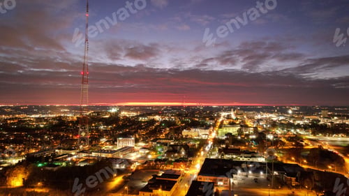 Preview: Nighttime view of a city with skyscrapers, including a radio tower at sunset.