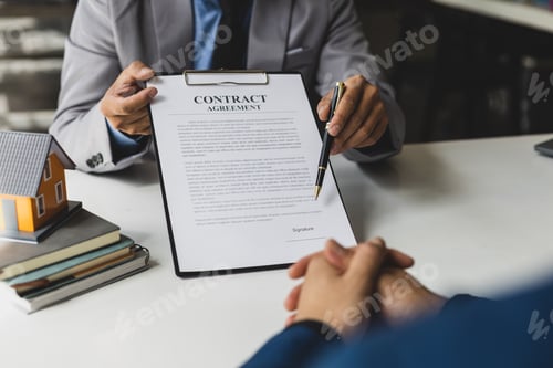 Preview: Real estate agent is discussing and explaining the terms of the home purchase contract.