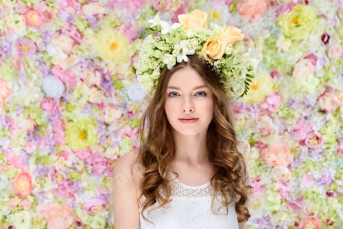 Preview: attractive young woman in floral wreath on floral background