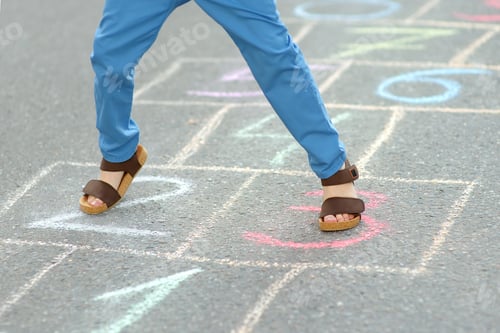Preview: Little boy's legs and hopscotch drawn on asphalt. Child playing hopscotch game on playground