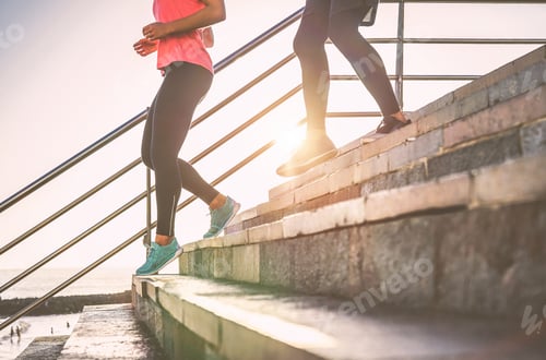 Preview: View of runners legs having a workout session on city stairs outdoor