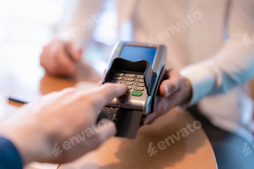 Preview: Man using credit card reader, close-up