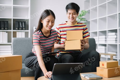 Preview: Young couple checklist with cardboard box at home - Business online and delivery concept.