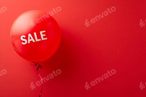 Preview: Black Friday advertisement idea. Overhead view of a red "sale" helium balloon on red background