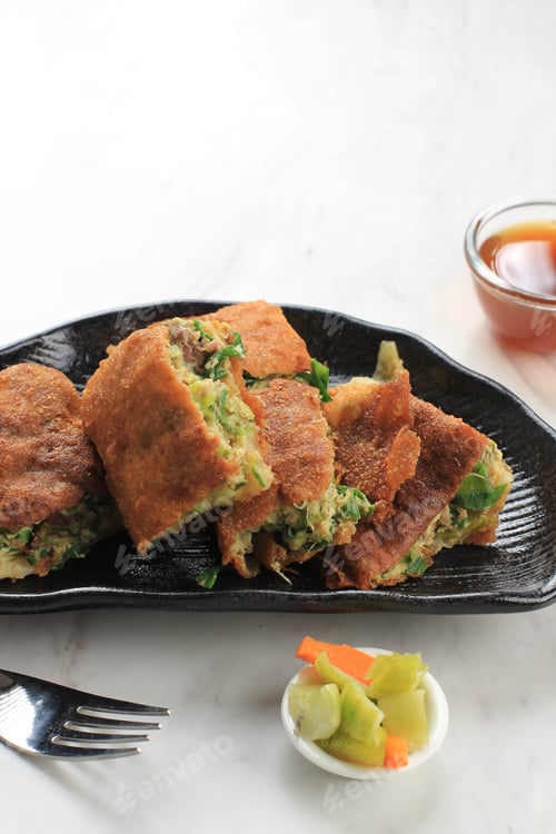 Preview: Martabak Telur is Popular Street Food in Indonesia. Egg, Spring Onion Wrapped with Thin Flour Batter