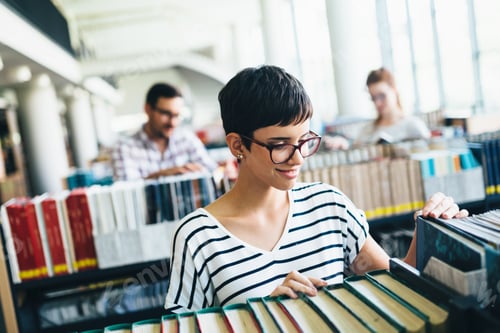 Preview: Portrait of young female student in library