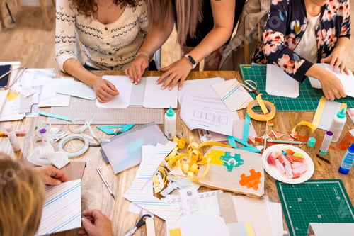 Preview: Scrap Booking Workshop. Close-up of a woman working on paper.