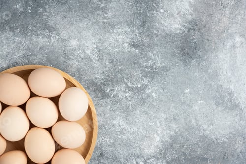 Preview: Wooden plate of fresh organic raw eggs on marble surface