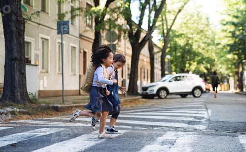 Preview: Small girls crossing street outdoors in town, coronavirus concept.