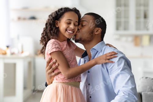 Preview: Loving african american man kissing his happy little daughter