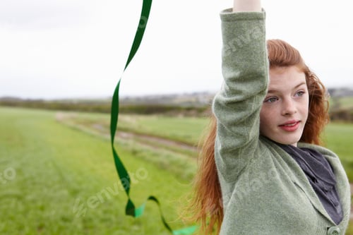 Preview: Teen Girl Playing in a Field with Ribbon