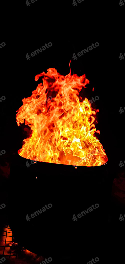 Preview: Black bowl sits illuminated by a bright orange flame in a dark setting