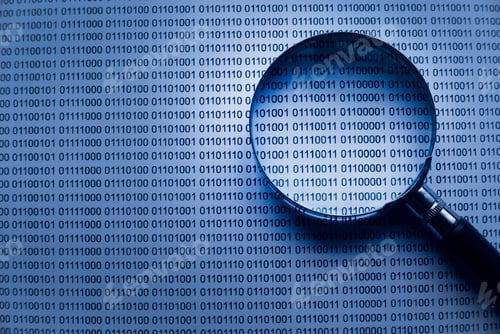 Preview: Selective focus of magnifying glass on a paper sheet of binary code.