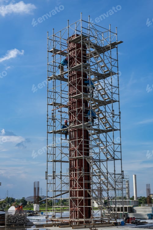 Construction Workers on Scaffolding Assemble Column Formwork