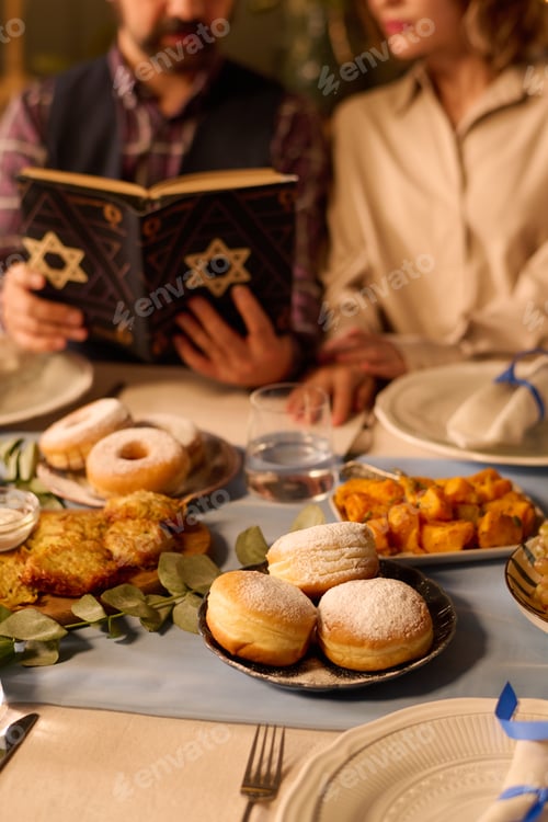 Preview: Table with Fresh Baked Pastry and People Reading Torah