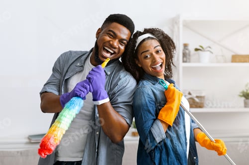 Preview: Joyful Black Couple Having Fun During Spring-Cleaning Home, Singing Together