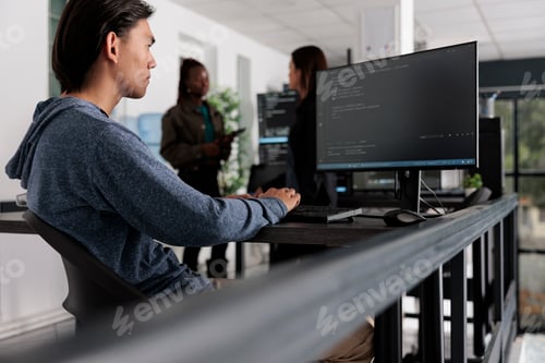 Preview: Asian app developer analyzing compiling html code