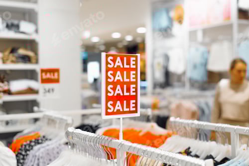 Preview: Sale in a clothing store. Red sign saying Sale inside the store, blurred background. Product