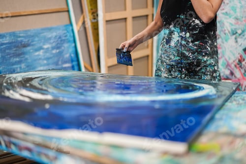 Preview: Artist woman painting inside her atelier studio at home - Focus on hand