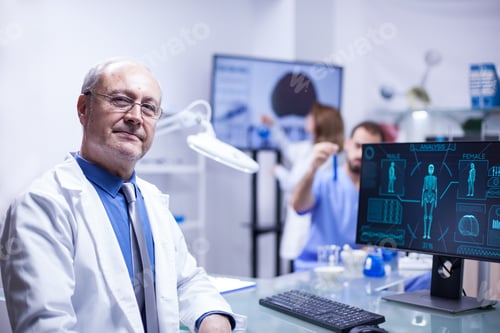 Preview: Portrait of senior scientist man looking at the camera in a science laboratory