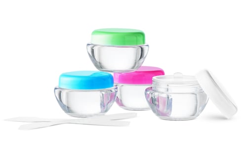 Preview: Clear cosmetic jars stacked with lids on a plain background