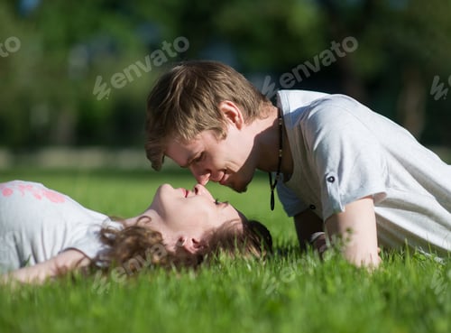 Preview: Affectionate Couple Lie on Green Grass Together