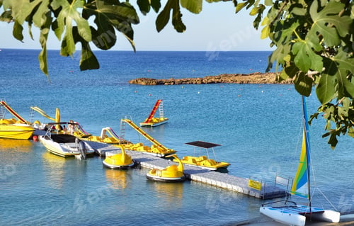 Preview: Excursion and fishing boats moored on a beautiful beach of a Maldives in the blue water.