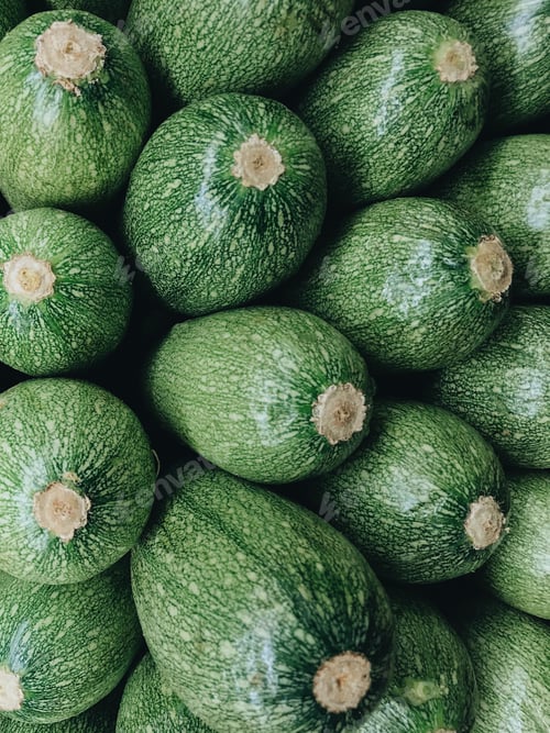 Vista previa: Fresh green zucchini stacked and ready for purchase at a local grocery store