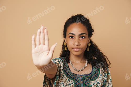 Preview: Young black woman wearing earrings showing stop gesture