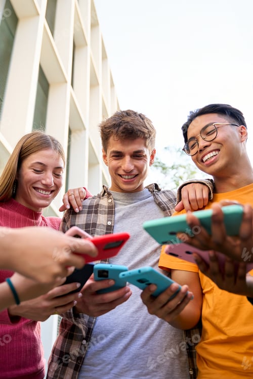 Preview: Group of multiracial generation z young smile happily watching funny videos on a smart phone