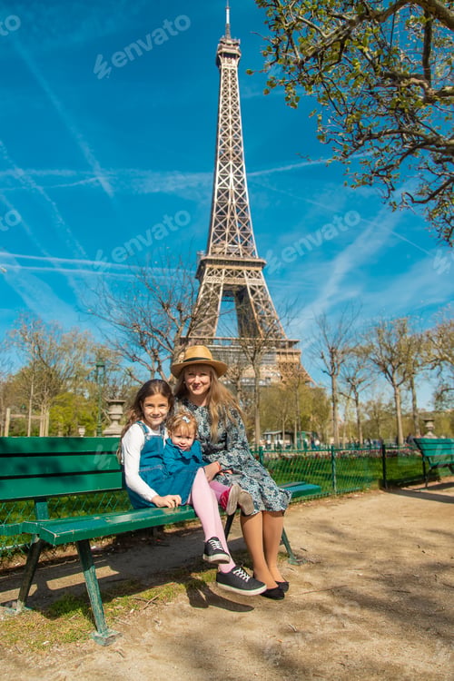 Preview: Mom and children near the eiffel tower. Selective focus.