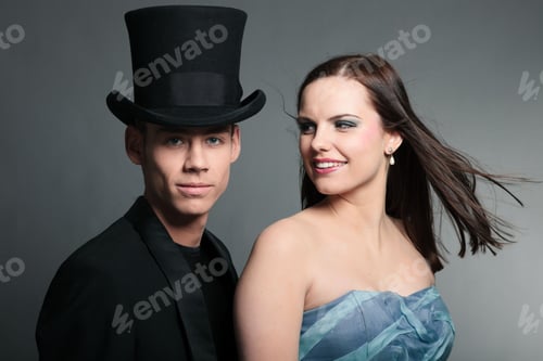 Preview: Happy Young Couple Isolated On Grey Background. Fashion Style Studio Portrait.