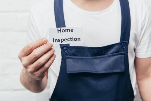 cropped image of male craftsman showing card with lettering home inspection cropped image of male craftsman showing card with lettering home inspection