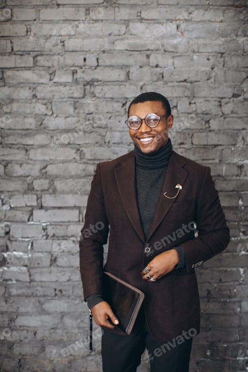 Preview: Smiling young adult man wearing stylish blazer and glasses