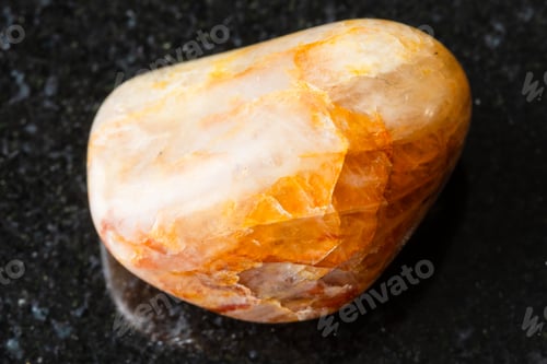 Preview: sample of polished orange quartz rock on black