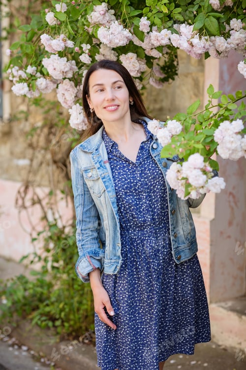 Preview: Lifestyle portrait of young stylish woman staying on the street in old town