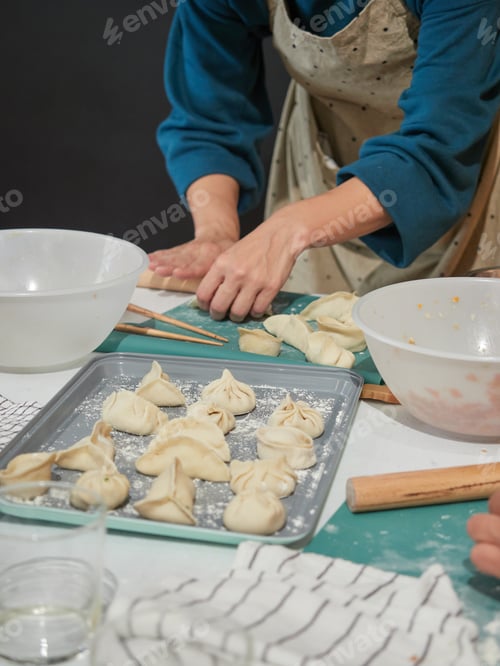 Preview: woman making traditional dim sum Chinese dumplings, stuffed dough