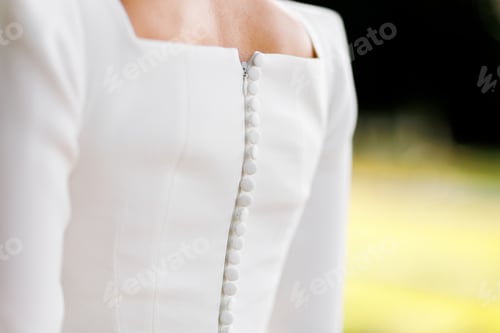 Vista previa: Back view of elegant white wedding dress with buttons in row down and zipper. Fashionable stylish