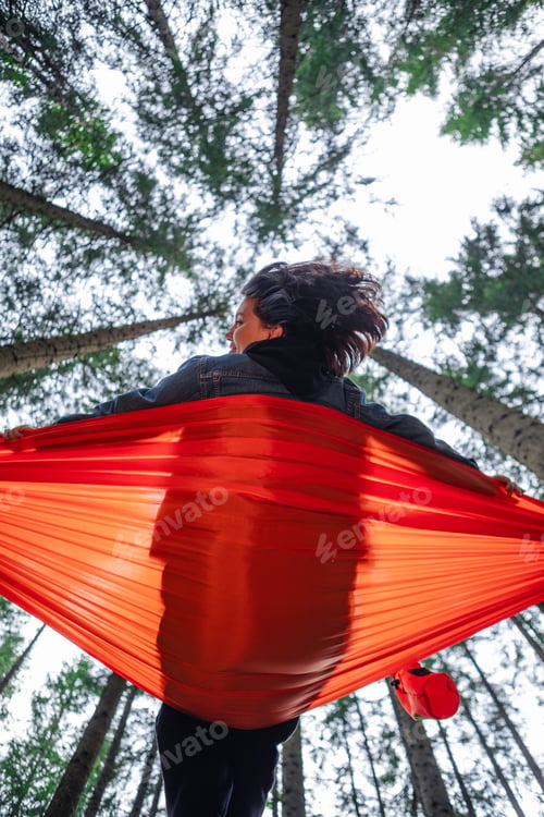 Preview: happy woman on hammock in the forest