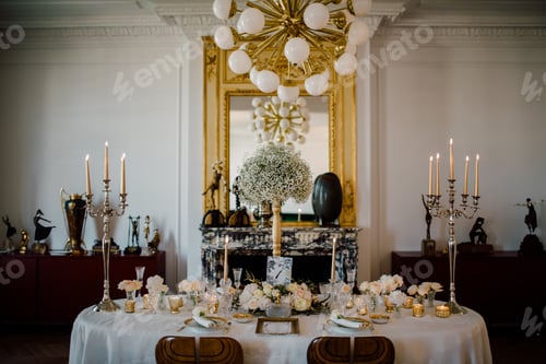 Preview: Elegant Table Setting with Floral Arrangement and Candles